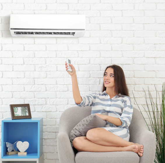 young woman turning on the newly installed aircon at home